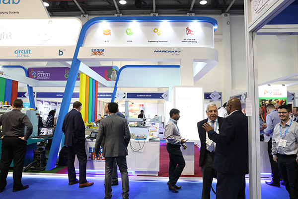 Visitors at GESS Dubai look at STEM products from Lego and Atlab